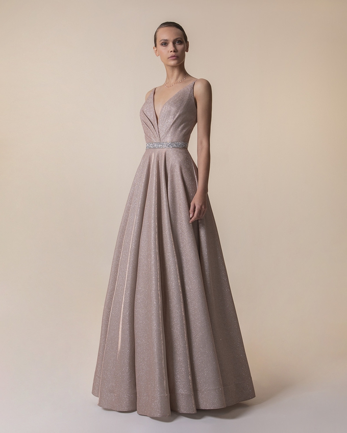 Long evening dress with shining fabric and beading around the waist