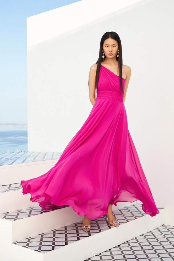 Flowy statement dress with one shoulder and defined waist.