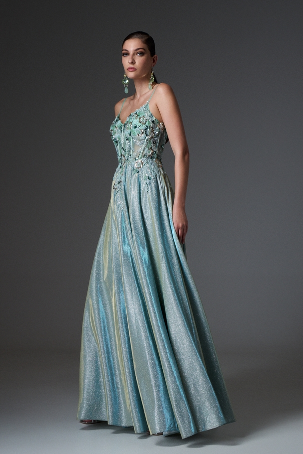 Evening long dress made of shiny fabric with embroidered top and boning