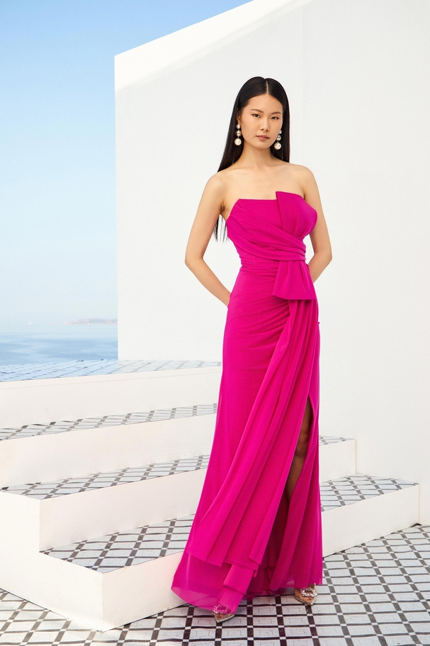 Strapless cocktail dress in stretch tulle with bow and draped bodice.