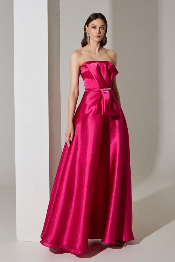 Evening long strapless organza dress with bow on the top and embroidery at the waist