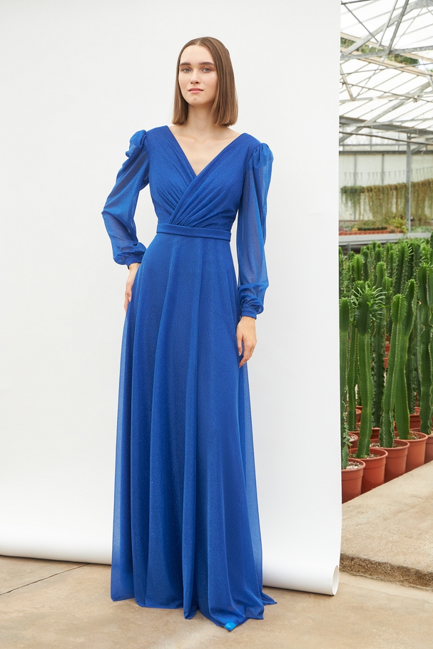 Long cocktail dress with shining fabric and long sleeves
