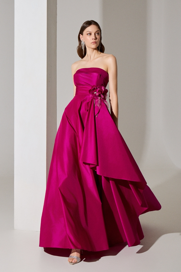Evening long strapless dress with a flower and embroidery on the side