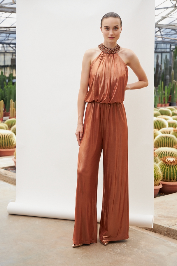 Cocktail jumpsuit with shining fabric and beading at the neck