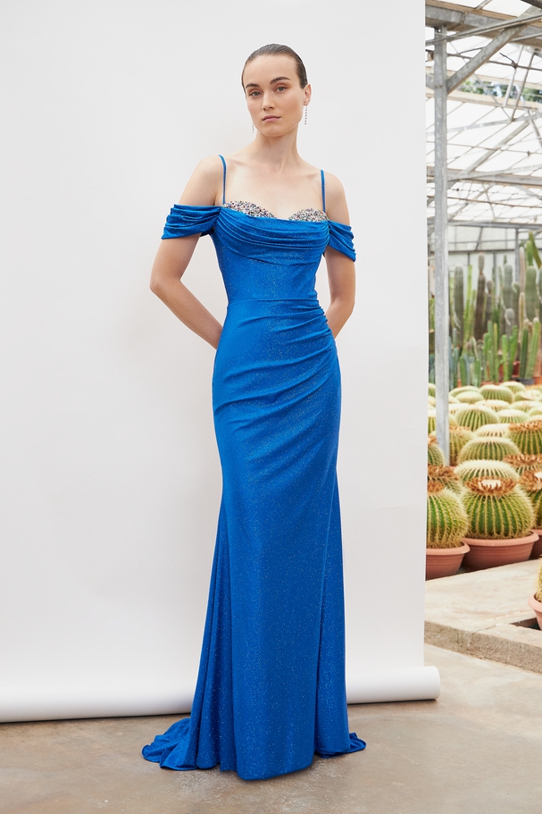Long evening dress with shining fabric , fully beaded top and short sleeves