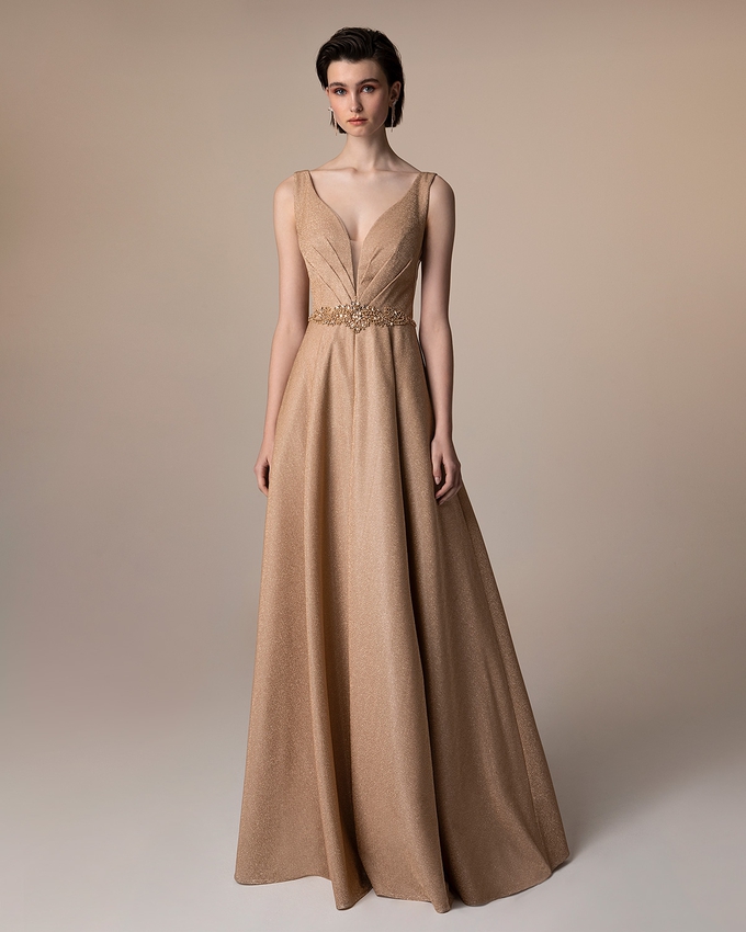 Long evening dress with shining fabric and beaded waist