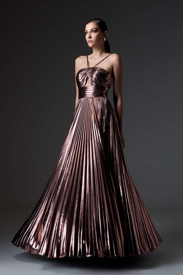 Evening long pleated dress made of shiny fabric with an opening on the top