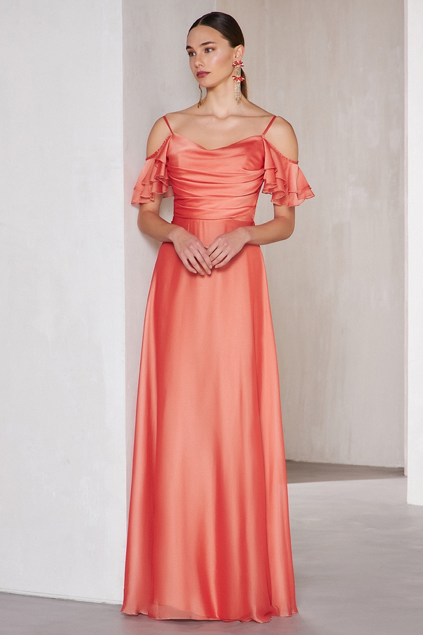 Long cocktail dress with shining fabric and sleeves