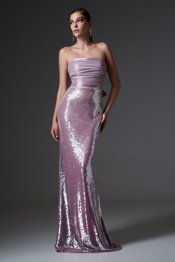 Evening long fully embroidered sequin dress with shiny fabric on the top and a bow on the back