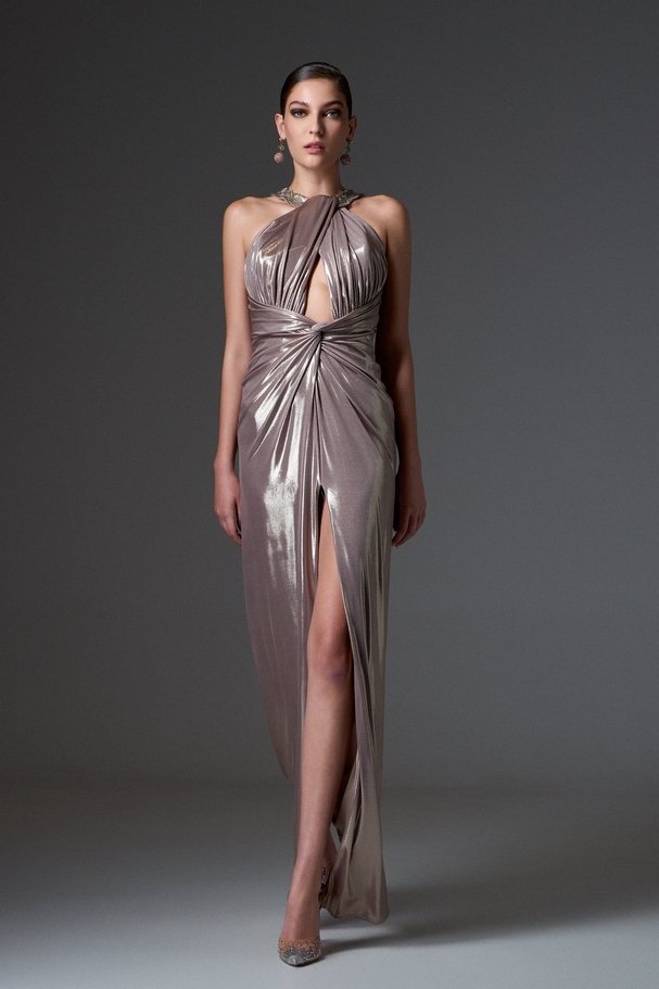 Evening long backless dress made of shiny fabric, embroidery on the neckline, and a slit