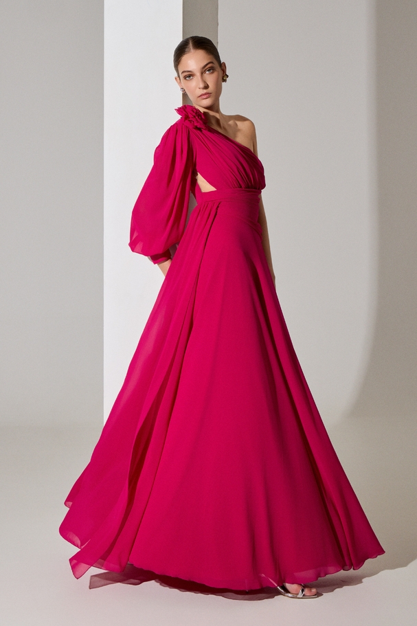 Evening long one-shoulder dress with a long sleeve and a flower on the shoulder
