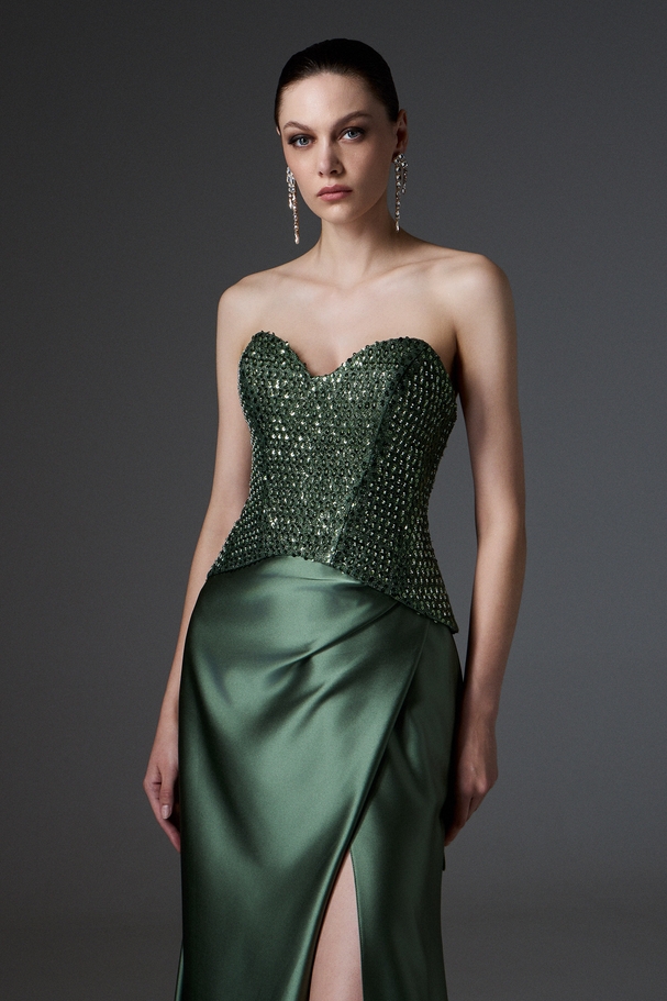 Evening long strapless dress with satin skirt, fully embroidered top, and laces on the back