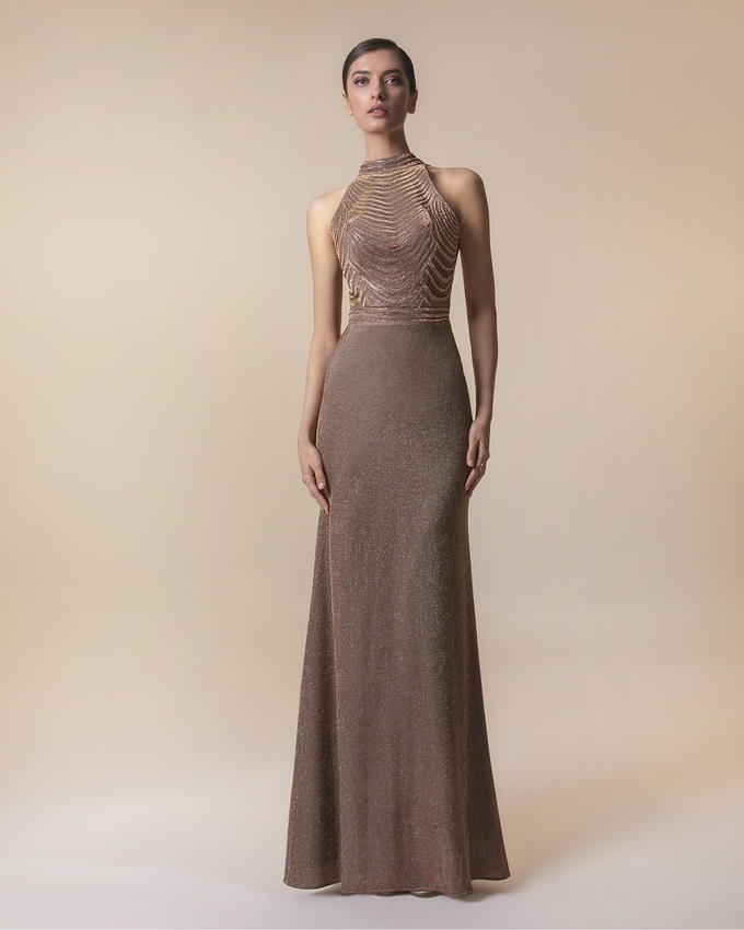 Long evening dress with shining fabric with fully beaded top
