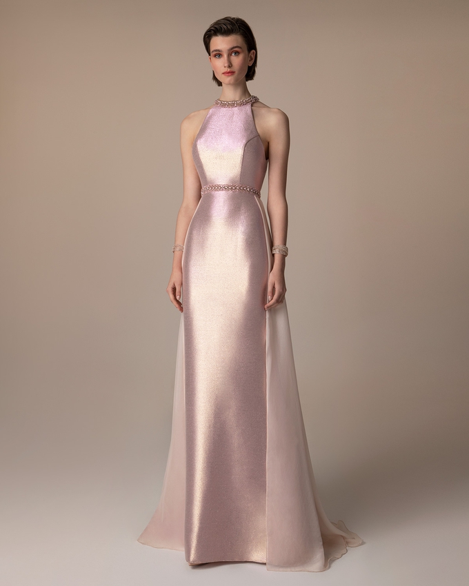 Long evening dress with shining fabric and beading on the neck and the waist
