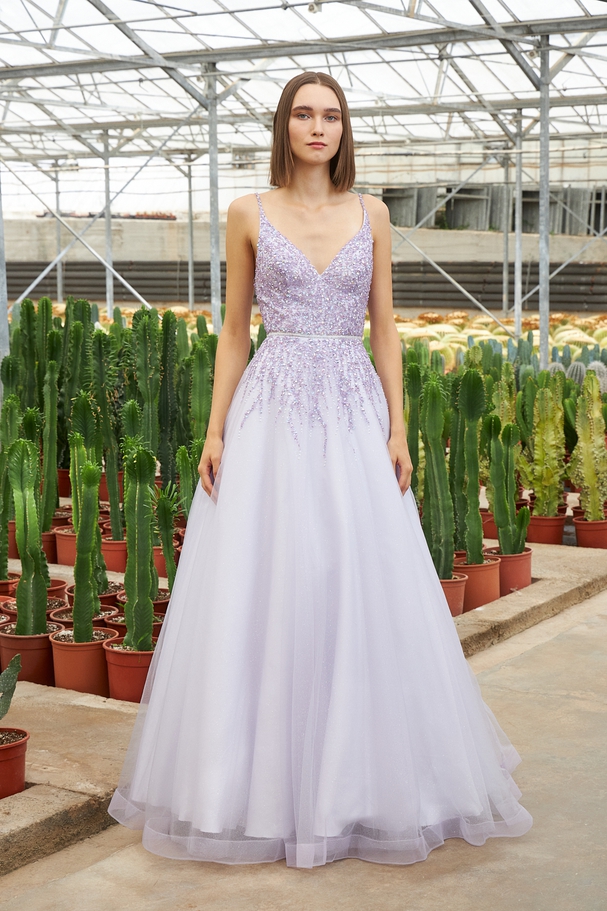 Long evening tulle dress with shining fabric and beaded top
