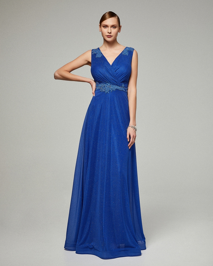 Long evening shining dress with applique beading on the waist and the straps