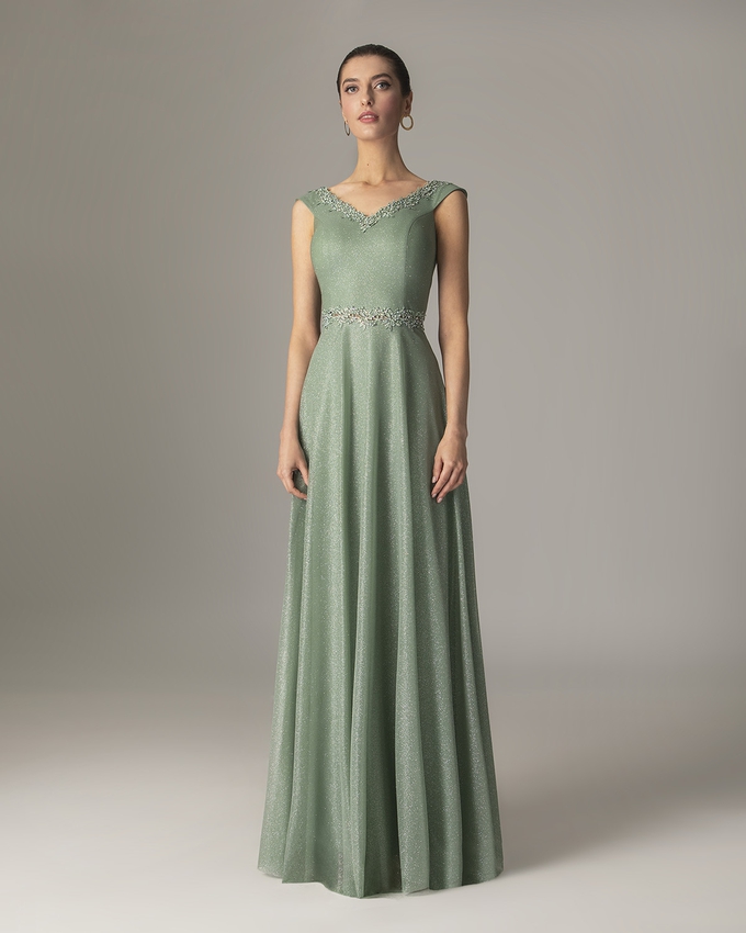 Long dress with shining fabric and beading on the waist and the top