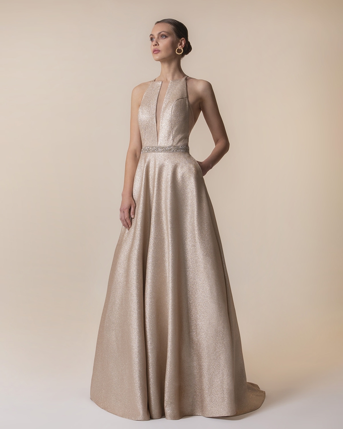 Long evening dress with shining fabric and beading around the waist