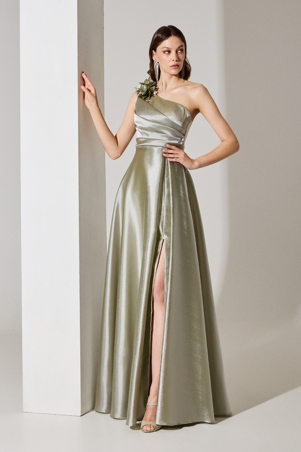 Evening long one-shoulder organza dress with a flower and embroidery on the shoulder