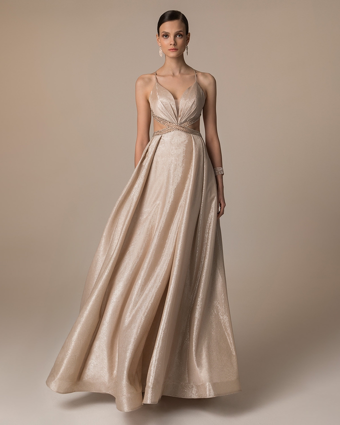Long evening dress with shining fabric and beaded top and straps