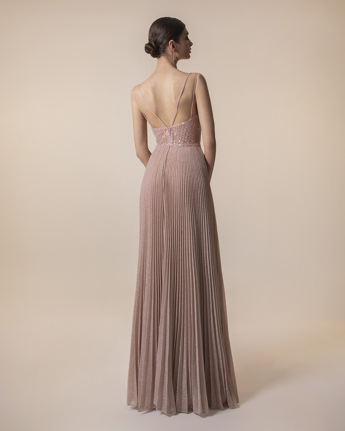 Long pleated evening dress with shining fabric and fully beaded top