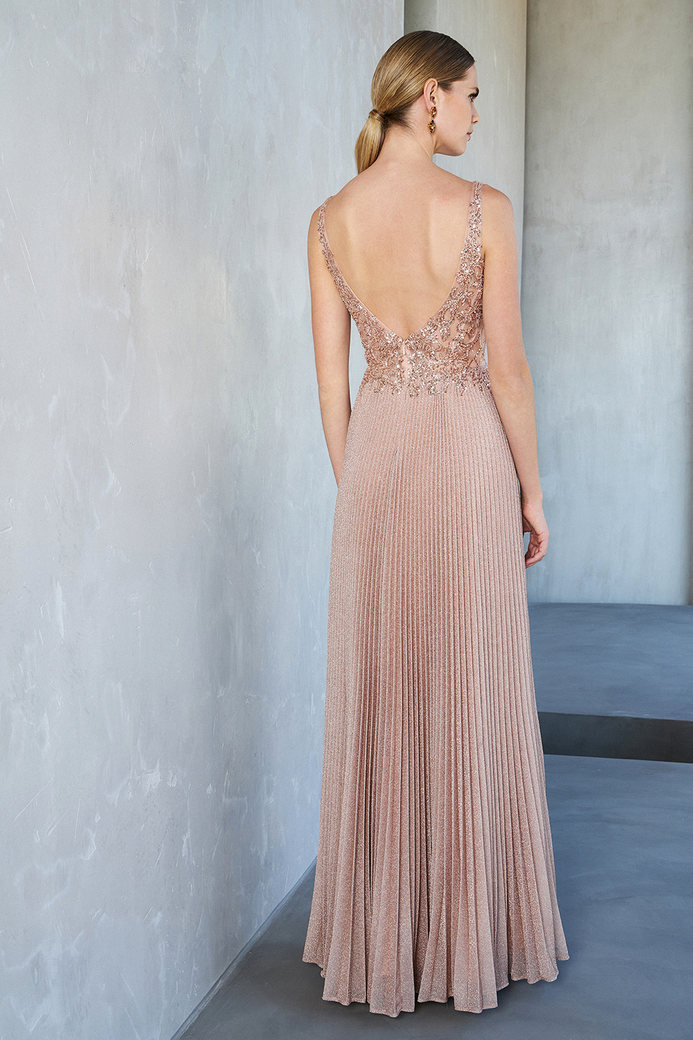 Long evening pleated dress with shining fabric and beaded top