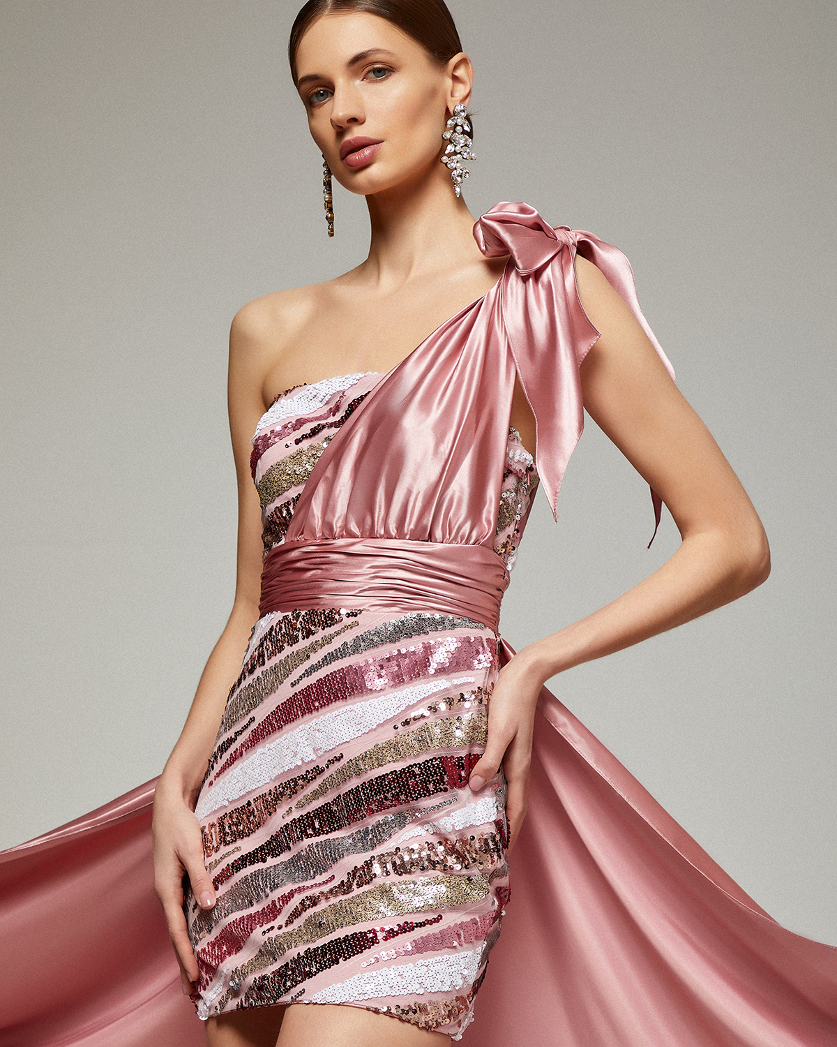One shoulder short evening dress fully beaded with sequences and tail with satin fabric