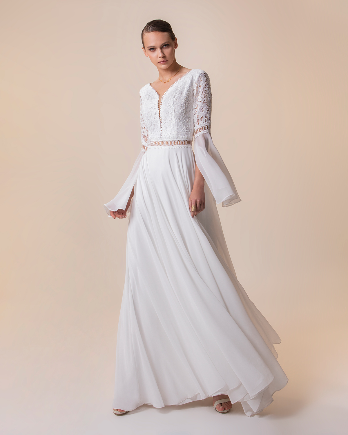 Long wedding dress with long sleeves and lace on the top
