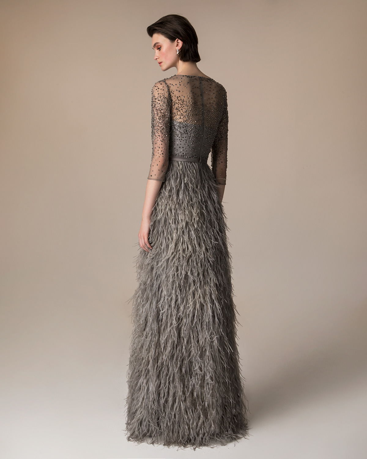 Long evening dress with skirt of feathers and gully beaded top